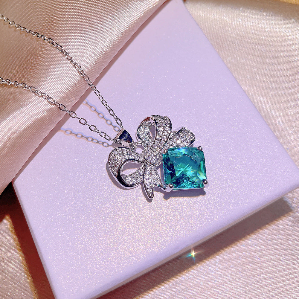 Sky Blue Topaz and Sparkling Bow Earrings, Necklace, Ring.