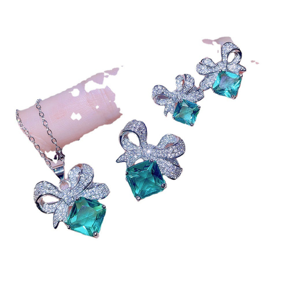 Sky Blue Topaz and Sparkling Bow Earrings, Necklace, Ring.