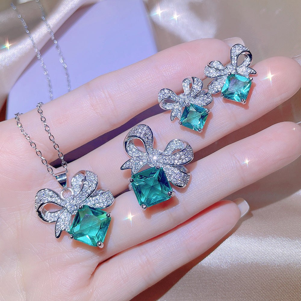 Sky Blue Topaz and Sparkling Bow Earrings, Necklace, Ring.