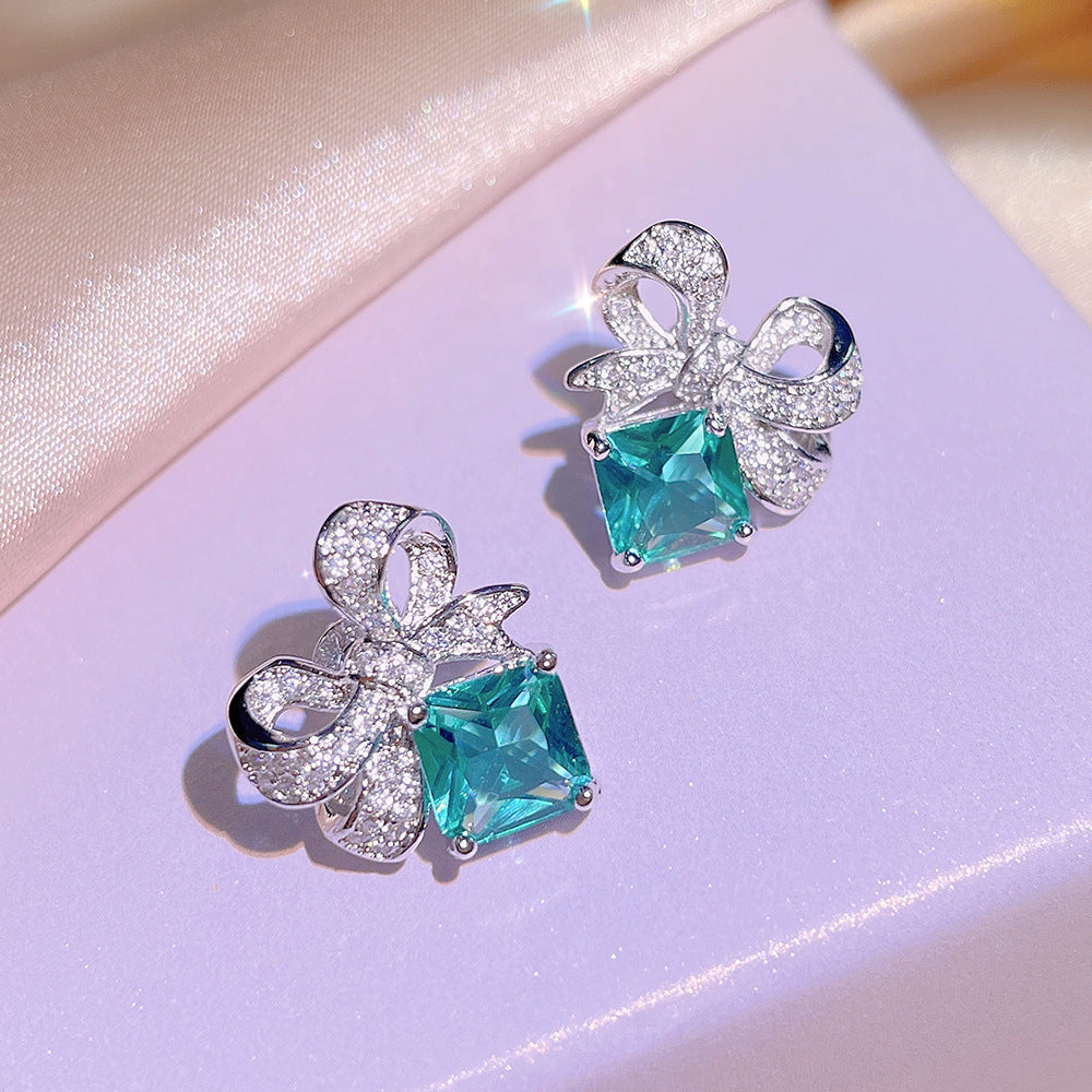 Sky Blue Topaz and Sparkling Bow Earrings, Necklace, Ring.