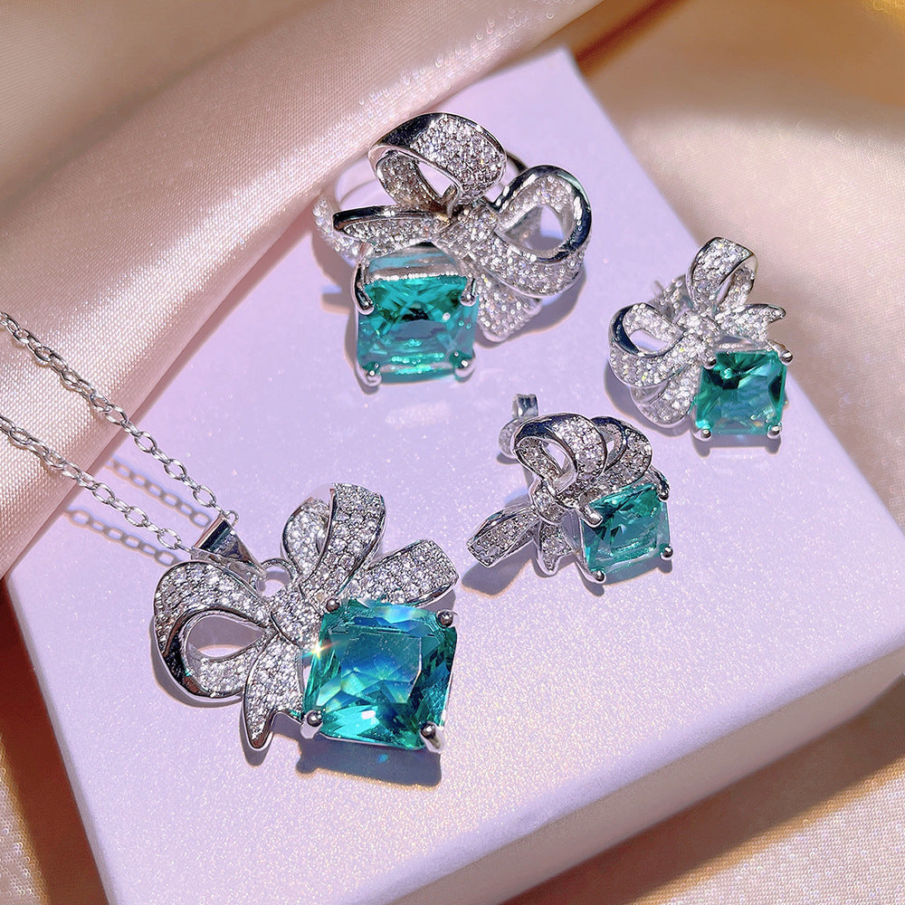 Sky Blue Topaz and Sparkling Bow Earrings, Necklace, Ring.